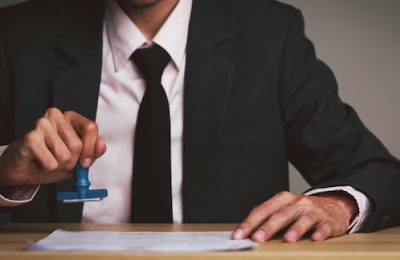 businessman-person-with-stamp-approval-public-notarization-certificate-document-his-desk-lawyer-approval-use-contract-acceptance-treaty-conditions-selection-stamping-agreement_661047-2878